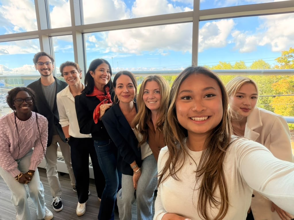 Vorleak taking a selfie with the project team and client in a bright room with large windows